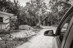 Driving on gravel path road in Tulum jungle nature Mexico. photo