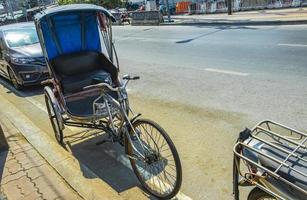 Old bike rickshaw rikshaw trishaw in Don Mueang Bangkok Thailand. photo