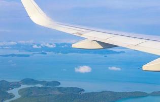 Flying over Thailand panoramic view of islands beaches turquoise waters.