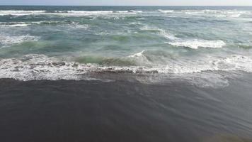 vista aérea de arriba hacia abajo de las olas gigantes del océano rompiendo y formando espuma