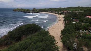 Aerial drone view of people Holiday In Gunung Kidul Beach, Indonesia video