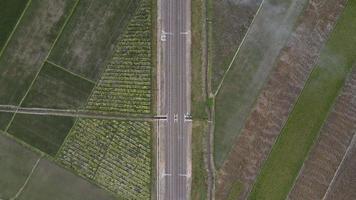 Aerial view of Railway with sky, clouds, sunlight, and green grass in Indonesia video