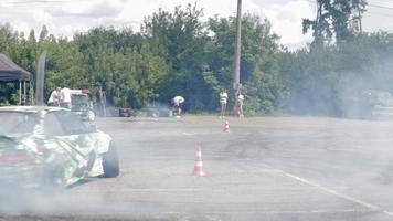 Drifting car, professional driver. Racing drift car with thick smoke from burning tires. Race car burnout. By car text in Russian physics of motion. Ukraine, Kiev - July 22, 2021. video