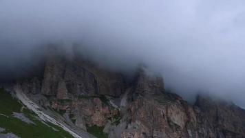 Gloomy rain clouds cover the top of a sheer cliff. video