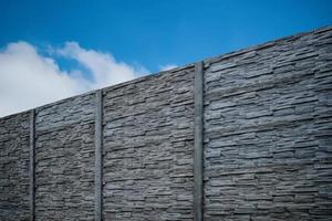 Fence of Pyrenean stone panels. Artificial concrete panels imitating natural stone. photo