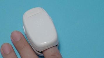 Oximeter usage. Finger pulse oximeter used to measure pulse rate and oxygen levels.