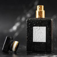 beautiful perfume bottle on black marble background photo