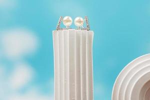 A beautiful Pearl Ear studs. Close-up of white pearl earrings. photo