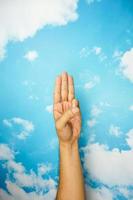 hand symbol isolated from sky background. concept of sign language photo