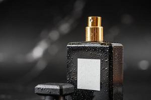 beautiful perfume bottle on black marble background photo