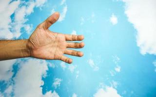 hand symbol isolated from sky background. concept of sign language photo