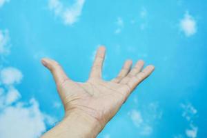 hand symbol isolated from sky background. concept of sign language photo