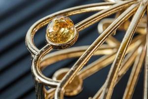 yellow natural gemstone, Gems or gems on shiny gold photo