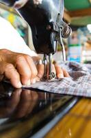 Man with a sewing machine photo