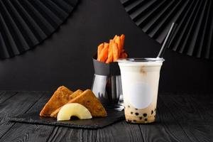 Milk bubble tea with tapioca and fried chicken with sweet potatoes.