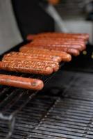 Grilled skewers of meat on the coals, with smoke. street food. photo