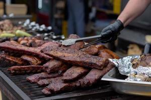 Grilled skewers of meat on the coals, with smoke. street food. photo