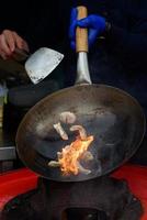 A chef prepares Chinese food at a street food festival. photo