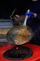 A chef prepares Chinese food at a street food festival. photo