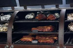 Grilled skewers of meat on the coals, with smoke. street food. photo