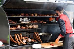 Grilled skewers of meat on the coals, with smoke. street food. photo