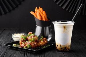 Milk bubble tea with tapioca and fried chicken with sweet potatoes.