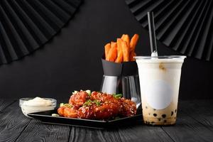 Milk bubble tea with tapioca and fried chicken with sweet potatoes. photo