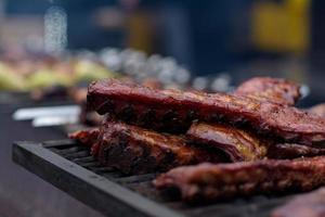 Grilled skewers of meat on the coals, with smoke. street food. photo