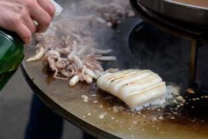 Cooking shrimp, prawn skewers on grill at street food festival - close up photo