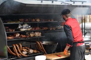 Grilled skewers of meat on the coals, with smoke. street food. photo