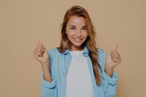Overjoyed young european lady clenches fists with triumph photo