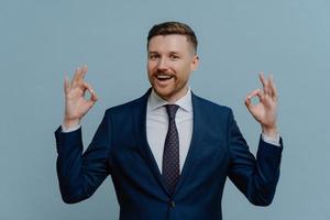 Happy businessman showing ok sign and smiling photo