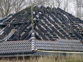 burnt out roof truss of unused dwelling house photo