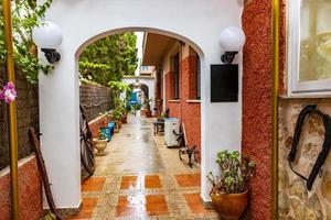 Hostel entrance with decorations blue wheelbarrow Cala Figuera Mallorca. photo