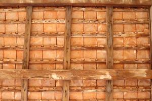 Thai style under roof of ancient building, brown wood construction and roof tiles of under roof, Thailand. photo