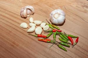 white garlic and Chili on wooden floor for cooking photo