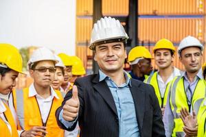 Professional Engineering and worker team congratulated success by applaud their leader after construction project complete and he hold hand with thumb up gesture photo