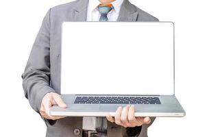 Business man stand  with laptop computer facing the camera and showing you something on laptop. photo