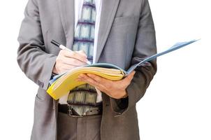 Writing down his ideas, Businessman with a document file in hands isolated on white background photo