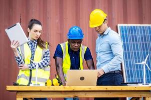 Two male energy engineers with his woman colleague team discussing new project about to invest in install solar cells outside building or industrial factory photo