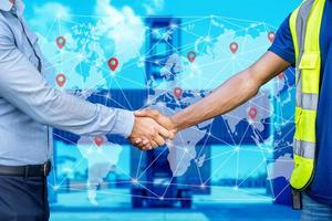 Foreman and engineer shake hand together with concept of successful in shipping, Map global logistics partnership connection of Container Cargo freight ship for Import Export background photo