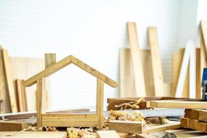 DIY project at home concept, House made of wood with craft tools on workbench.Table for making handmade wood work at carpenter's home. photo