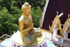 Big golden Buddha statue on round base. some golden color peel off statue, Thailand. photo