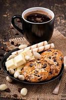 Cup of coffee with white chocolate, almonds and cookies photo
