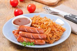 Sausages and fried cabbage photo