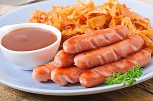 Sausages and fried cabbage photo
