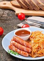 Sausages and fried cabbage photo