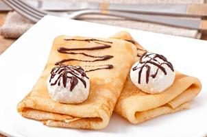 Pancakes with ice cream and chocolate sauce photo