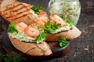 Bruschetta with a paste of green peas and shrimps photo