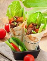 Tortilla wraps with meat and fresh vegetables photo